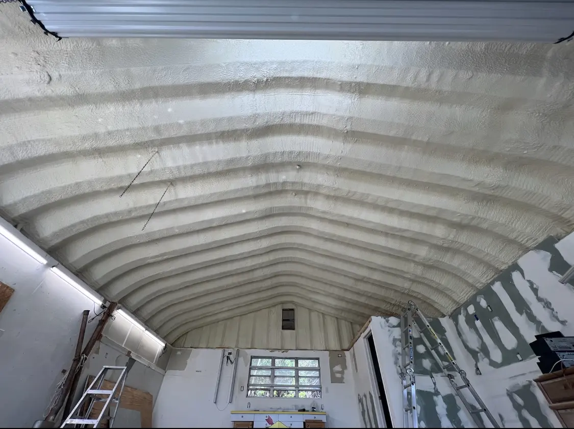 Spray polyurethane foam applied to the underside of a metal roof deck in Greendale